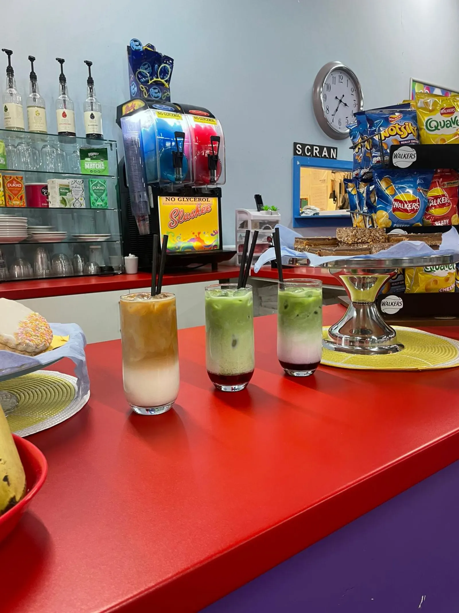 Bright slush and matcha drinks on the WeePlay café counter