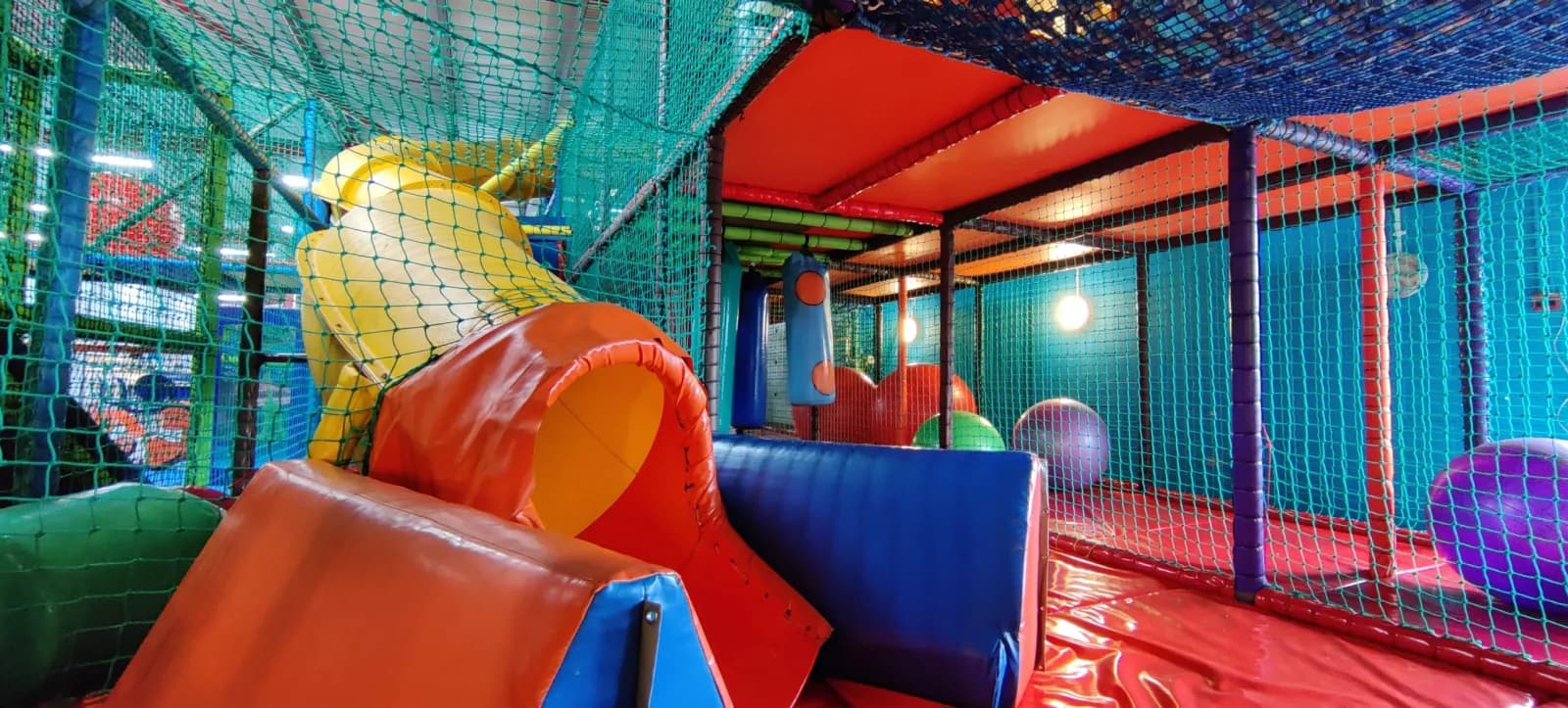 Bright soft play slides and a ball pool inside WeePlay